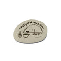Round wooden sign with illustrations and text against a blue sky