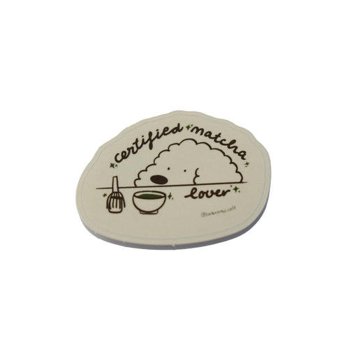 Round wooden sign with illustrations and text against a blue sky
