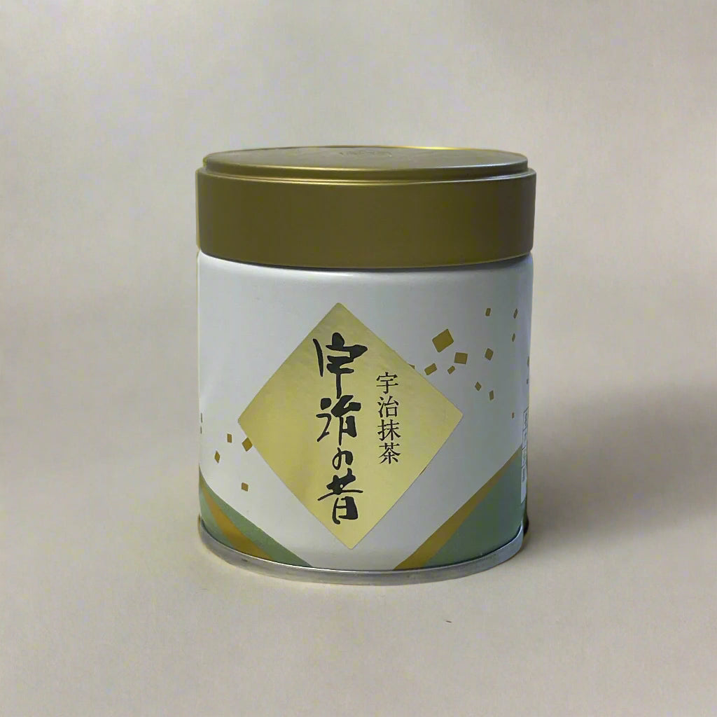 White container with gold lid on a textured white background