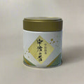 White container with gold lid on a textured white background